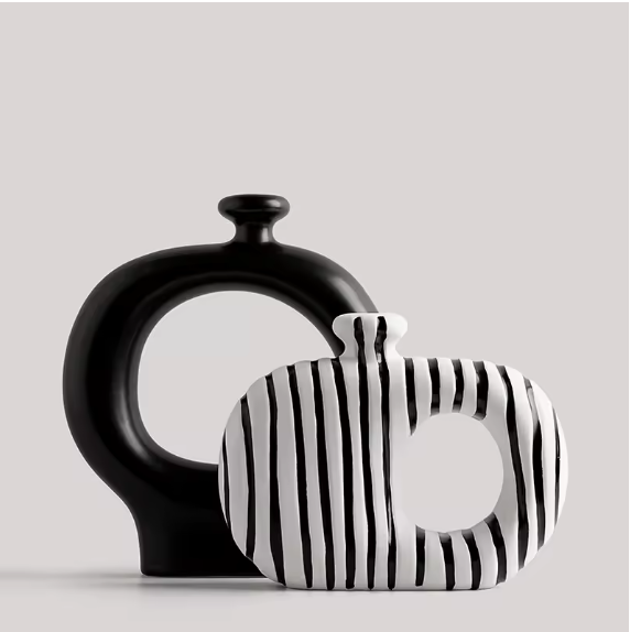 Set of two ceramic vases – tall matte black circular vase and compact white zebra stripe square vase