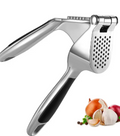 Stainless steel hand press garlic crusher and chopper with soft black handle and perforated pressing plate