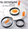 Non-stick fried egg mold rings with orange silicone handles showing a perfectly shaped fried egg on a white plate